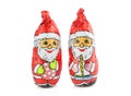 Two chocolate wrapped in foil santas isolated on white background. Holiday treats
