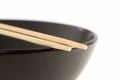 Two chopsticks on a black bowl Royalty Free Stock Photo