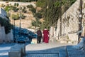 Two Christian pilgrims walking out from the Lions` Gate, located in the Eastern Wall of Jerusalam old city, Islamic quarter, the