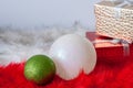 Two Christmas balls on red and white fur with gift boxes. Royalty Free Stock Photo