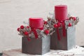 Two Christmas floral decorations with red candles Royalty Free Stock Photo