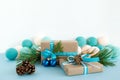 Christmas gift boxes wrapped of craft paper, blue and white ribbons, decorated of fir branches, pine cones and Christmas balls. Royalty Free Stock Photo