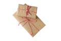 Two Christmas and New Year gift boxes wrapped in brown craft paper with red and white baker's twine Royalty Free Stock Photo