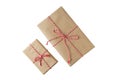 Two Christmas and New Year gift boxes wrapped in brown craft paper with red and white baker's twine Royalty Free Stock Photo