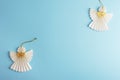 Two Christmas paper angels on light blue background. Holiday concept. Top view, flat lay, copy space