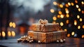 two christmas presents beautifully wrapped with blurred bokeh and lights in the background Royalty Free Stock Photo