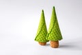 Two Christmas trees made of waffle cones and champagne corks on a white background.
