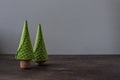 Two Christmas trees made of waffle cones and champagne corks on a wooden table