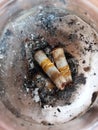 Two of cigarrets in ashtray with the ashes on the table Royalty Free Stock Photo