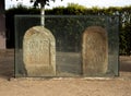 Two cinerary urns of the Voconian and Julius families on a Roman stone tombstone with inscriptions from the Los Columbarios