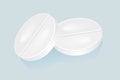 White pills isolated on blue background. Royalty Free Stock Photo