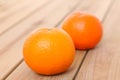 Two citrus tankan against wooden background