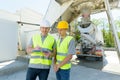 Two civil engineer looking blueprint in construction site Royalty Free Stock Photo
