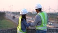 Two civil Engineering working with tablet on bridge highway