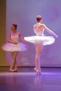 Two classical ballerina dancing on stage