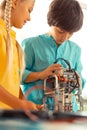 Two classmates working in pair at their science lesson.