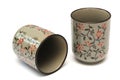 Two clay cups with red floral engraving design