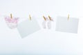 Two clean sheet of paper and babyÃâs clothes Royalty Free Stock Photo