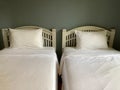 Two clean white beds with the light gray wall Royalty Free Stock Photo