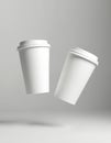 Two clean white disposable coffee cups float on a plain grey backdrop. These empty vessels are ready for branding or design use, Royalty Free Stock Photo