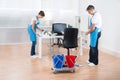 Cleaners With Cleaning Equipments Cleaning The Office Royalty Free Stock Photo