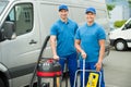 Two Cleaners Standing With Cleaning Equipments Royalty Free Stock Photo