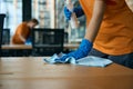 Two cleaning women disinfect tables in coworking area with special products Royalty Free Stock Photo