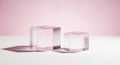 Two clear acrylic cubes casting soft pink shadows on a white surface against a pastel background Royalty Free Stock Photo