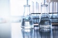 Two clear flask with water in front of test tube in education chemistry science laboratory background Royalty Free Stock Photo