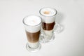 Two clear glasses of latte macchiato coffee Royalty Free Stock Photo