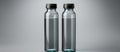 Two clear plastic water bottles with black lids on a gray background Royalty Free Stock Photo