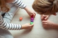 Two clever children study mathematics playing with dices on the floor Royalty Free Stock Photo