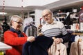 Two clients examining suit jackets