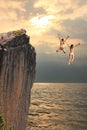 Two cliff jumping girls, coastal landscape Royalty Free Stock Photo