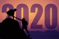 Two climbers on the peak silhouette with big new year 2020 and sunset Royalty Free Stock Photo