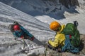 Two climbers on a steep snow-ice slope on insurance. Cracked glacier Royalty Free Stock Photo