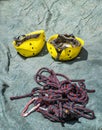 Two climbing helmets and mountaineer rope with a carabiner