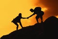 Two climbing people in mountains as symbol for help and success