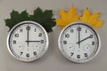 Two clocks, one showing two o\'clock and the other three o\'clock. A symbol of the change of time from summer to winter. Royalty Free Stock Photo