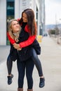 Two Close Woman Friends Having Fun and Piggybacking In City Royalty Free Stock Photo