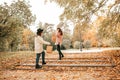 Two close female friends women walking at golden autumn park, stairs. Shopping day, buying in ecological textile bags Royalty Free Stock Photo