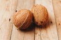 two closed coconuts on a wooden table Royalty Free Stock Photo