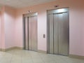 Two closed elevators in a business lobby