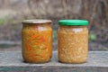 two closed glass jar with red yellow canned salad