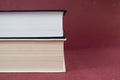 Two hardcover books stacked together on red background. Royalty Free Stock Photo