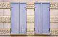 Two closed wooden shutters on an old house wall Royalty Free Stock Photo