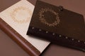 Two closed wooden wedding books with embossing. Dark and light wooden notebooks. Close up. Wedding photobook Royalty Free Stock Photo