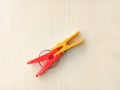 Two clothes pins, red and yellow. Royalty Free Stock Photo