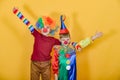 Two clowns hug and wave their arms around Royalty Free Stock Photo