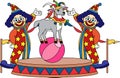 Two clowns are performing a circus act with a goat on a ball Royalty Free Stock Photo